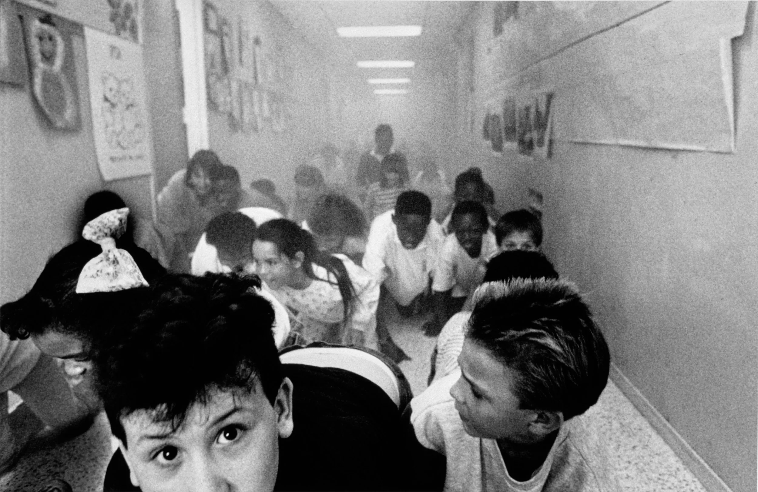 Where There Is Smoke… There Is No Fire — Students at Glen Oaks Park Elementary School in Baton Rouge, Louisiana are evacuated as part of a fire drill in which local firefighters filled the hallways with smoke simulating the circumstances of a real fire evacuation.  (Photo by Stephan Savoia)  Published by The Baton Rouge Louisiana State-Times & Morning Advocate Circa Mid 1980s