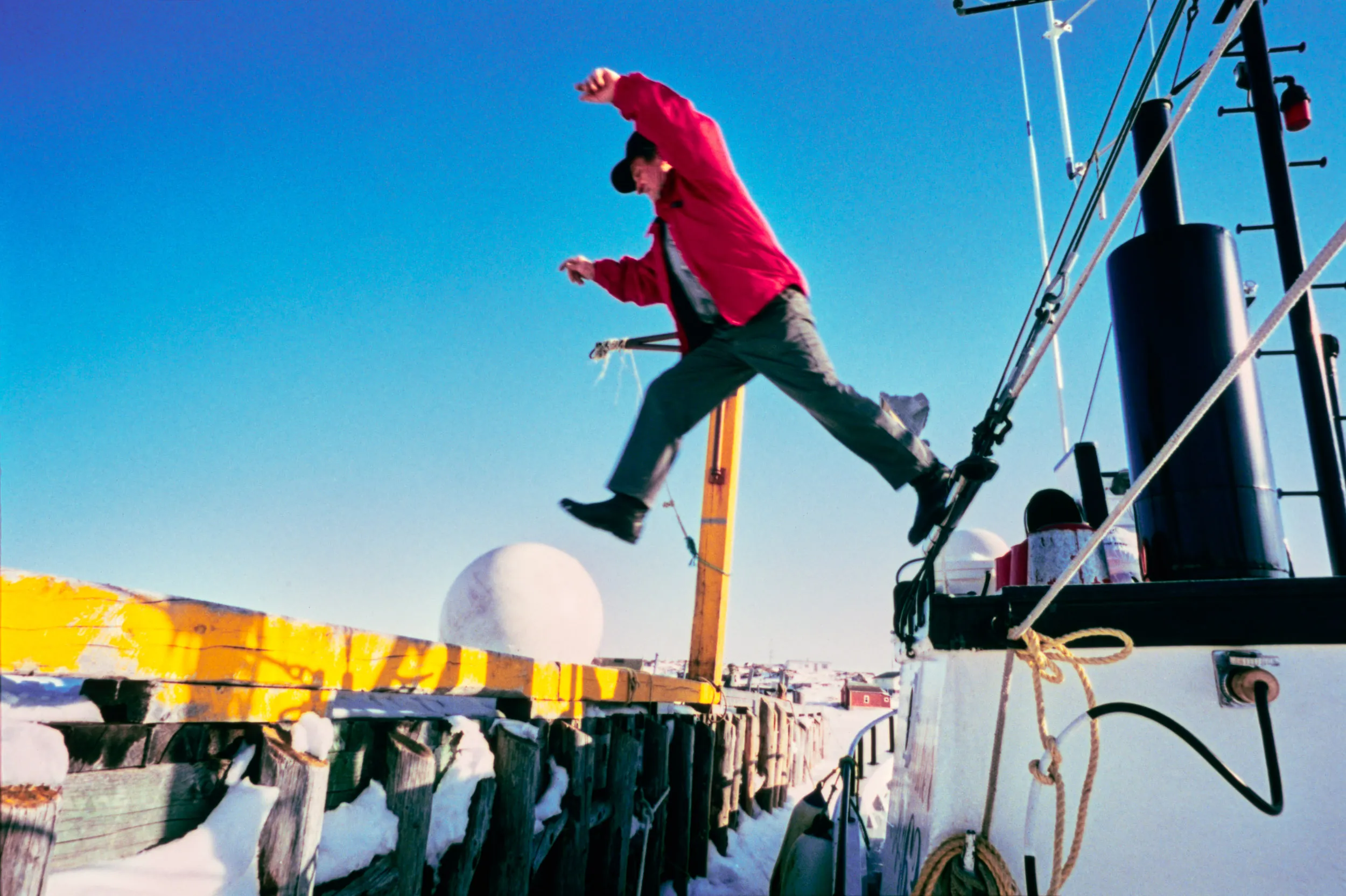 Jumping To The Unknown — Jack Troake a seal hunter and cod fisherman jumps from the upper deck of his 22 year-old fishing boat the “Loan Fisher” at fisherman’s wharf dock in Twillingate, Newfoundland Canada, Sunday March 27, 1994. Troak’s family has been fishing the waters of Notre Dame Bay on the northeast corner of Newfoundland island for 280 years. This will be the third year they are not allowed to fish for cod as the Canadian government extended a ground fishery moratorium for another two years. The moratorium remained in effect for 32 years from July 2, 1992 into 2024.  (AP Photo/Stephan Savoia)  © The Associated Press