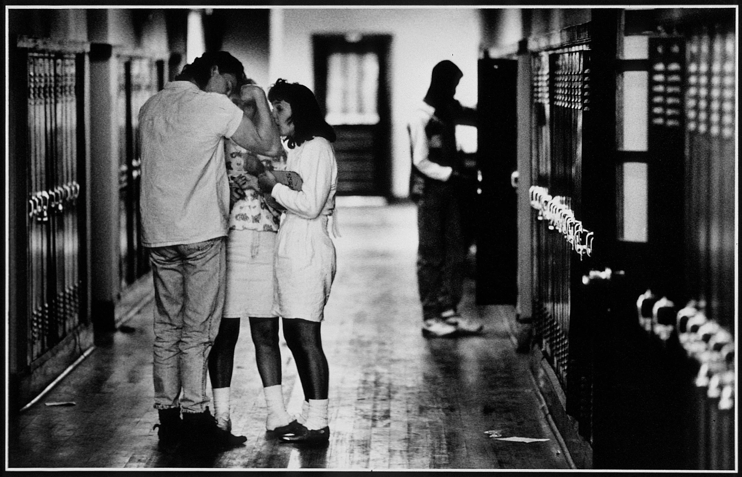 Showing Off — Rougon High School senior Mickey Tunstall shows off his biceps for two impressionable underclass coeds in a hallway of their high school in Rougon, Louisiana.  (Photo by Stephan Savoia)  Published by The Baton Rouge Louisiana Sunday Advocate Magazine