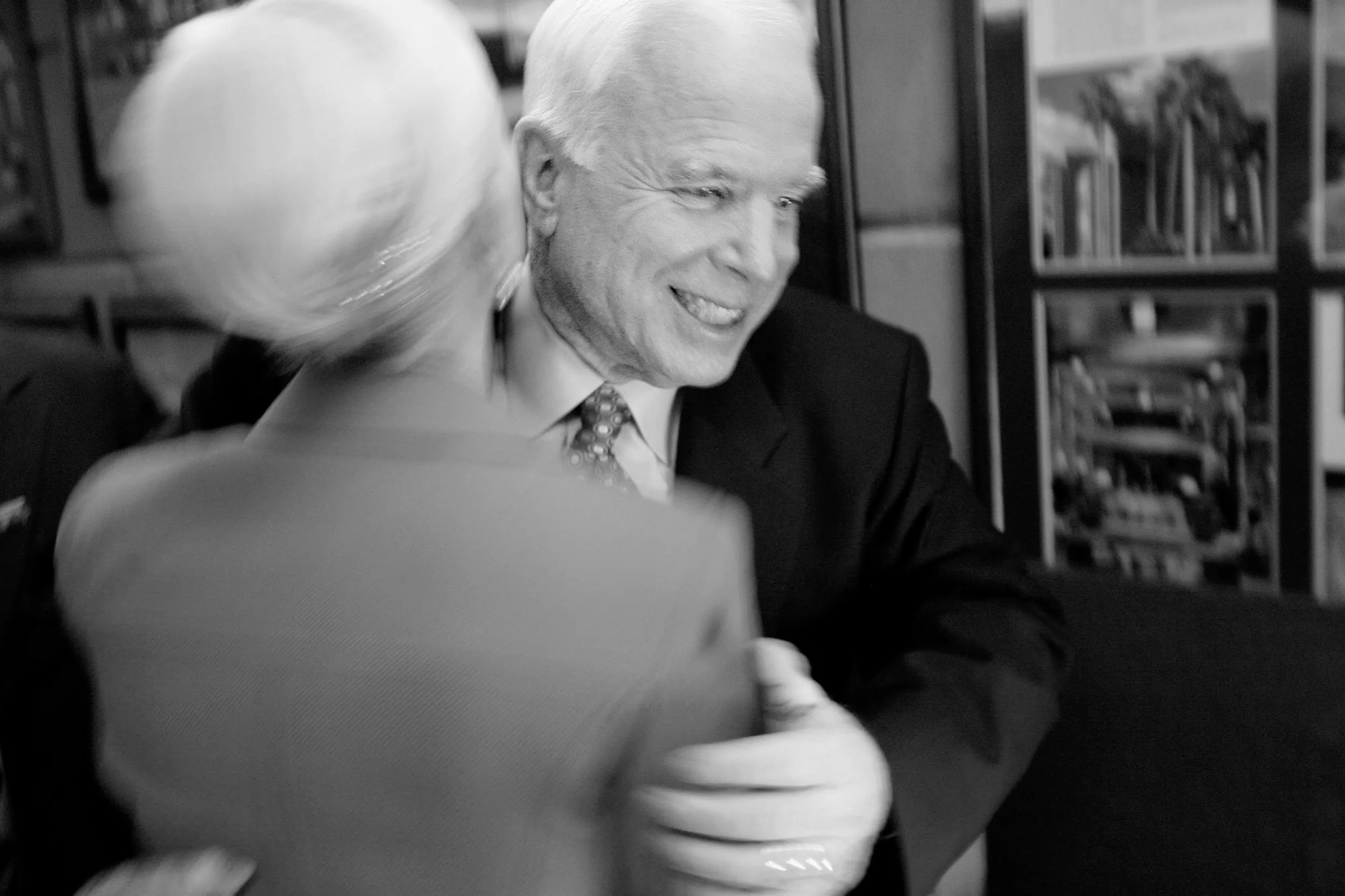 A California Dream — With the glow of a television screen cast upon his face Republican presidential hopeful, Senator John McCain, hugs his wife Cindy after hearing the television news announcement that he has won the California Presidential Primary at his election night command post in Phoenix, Arizona, Tuesday night, February 5, 2008.  (AP Photo/Stephan Savoia)  © The Associated Press
