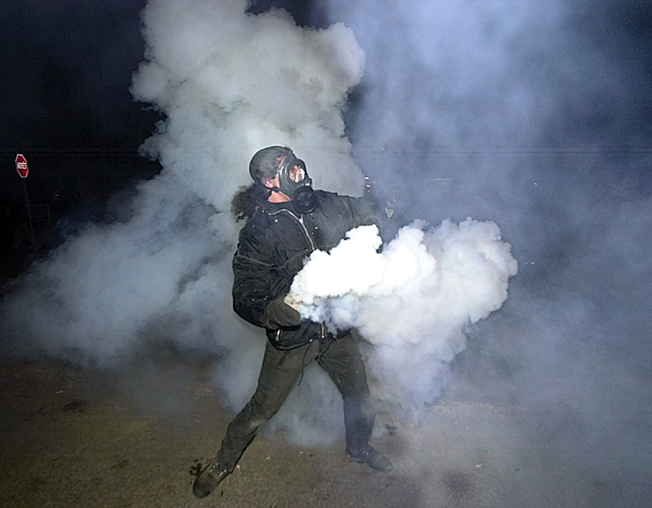 No Thank You — A protester at the Summit of the Americas in Quebec City, Canada throws a tear gas canister back at police during one of several confrontations Friday night, April 20, 2001. Confrontations between police and protesters began after demonstrators pulled a security fence down Friday afternoon shortly before the Summit, where 34 heads of state from the western hemisphere gathered to discuss trade issues, got underway.  (AP Photo/Stephan Savoia)  © The Associated Press